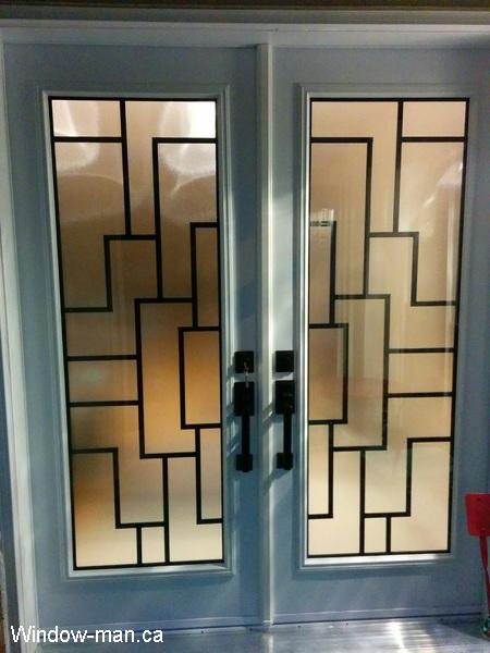 Double front entry steel insulated exterior doors. White. Modern Malibu wrought iron glass inserts